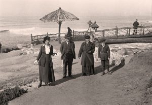 3 adults one child posing in front bridge 1915