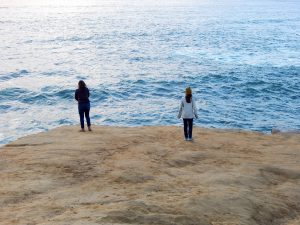 two girls on bluff overlooking Ocean