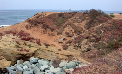 sunset cliffs natural park dirt hill rocks person on top