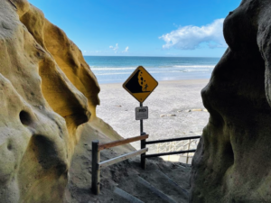 beach trail exit bluff sign ocean sand
