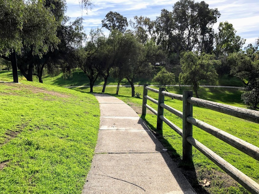 Guajome Park walkway grass trees wooden fence