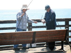 fishing oceanside pier scaled fishing pole two people